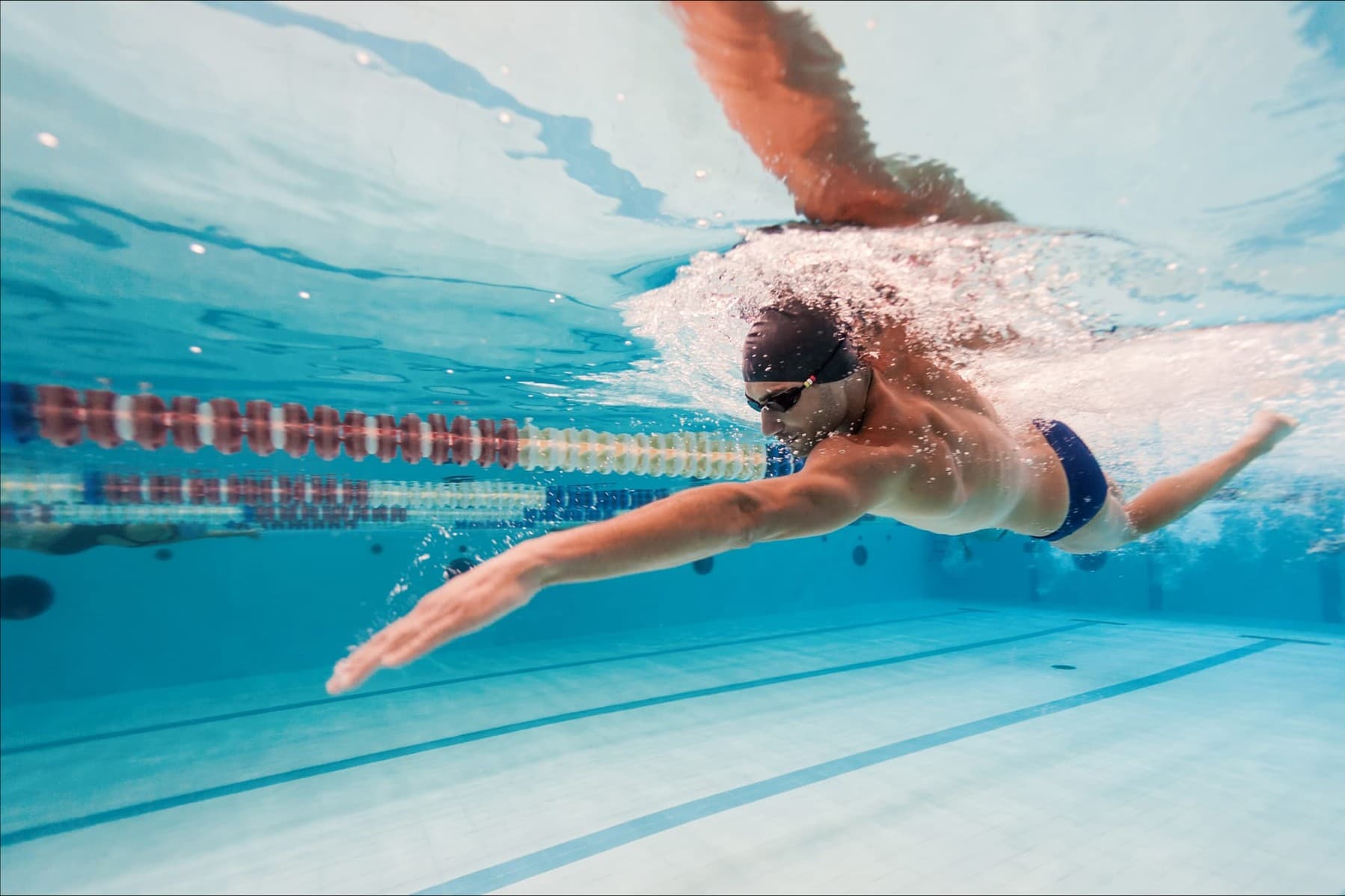 A swimmer mid-stroke, building endurance at a steady, unhurried effort